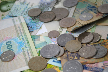 Old and new coins and banknotes of different countries closeup on white background