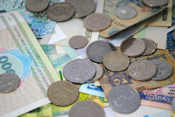 Old and new coins and banknotes of different countries closeup on white background