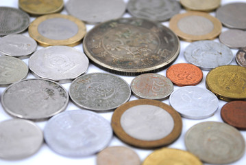 Old and new coins of different countries closeup on white background