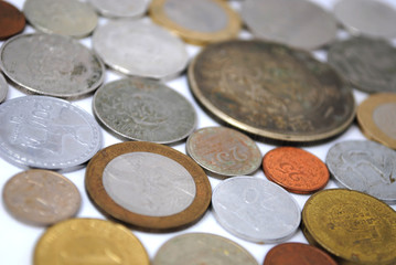 Old and new coins of different countries closeup on white background