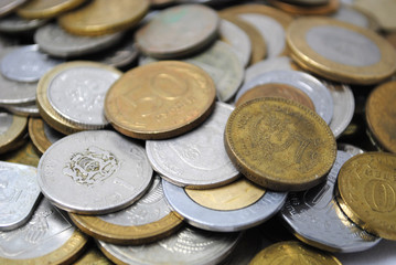 Old and new coins of different countries closeup on white background