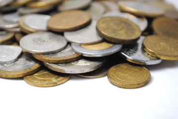 Old and new coins of different countries closeup on white background