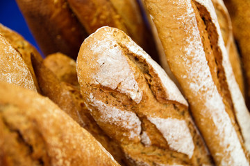 Bread baguettes in a basket in the baking shop close up