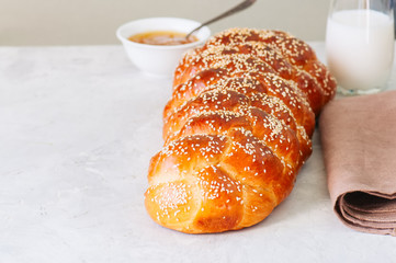 Traditional Challah Bread on a white stone background. Close up.