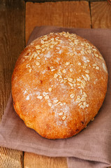 Homemade onion bread on a napkin. Wooden background. Rustic style.