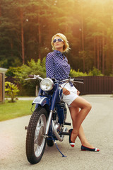 Fototapeta na wymiar beautiful girl on retro motorbike