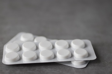 Fototapeta na wymiar Pills on gray background. Concept of medicine and health.