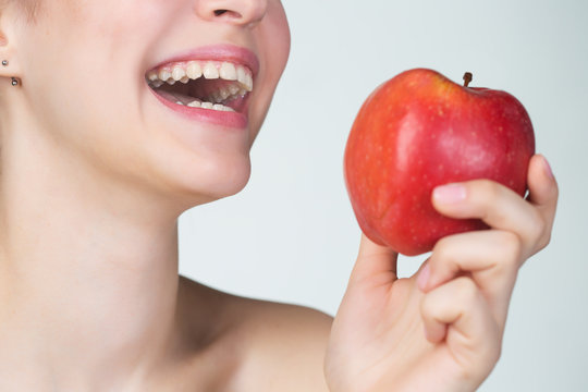 Young Woman Eating Red Apple