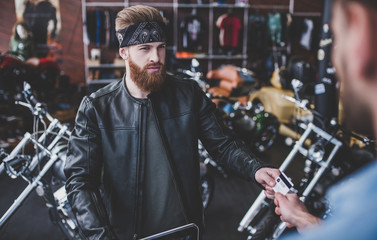 Fototapeta na wymiar Men in motorcycle shop