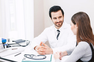 Doctor and woman patient consulting on doctors table in hospital.healthcare and medicine