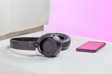 powerful wireless headphones lying on a white leather 