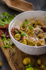Fresh cheese with olives, dried tomatoes