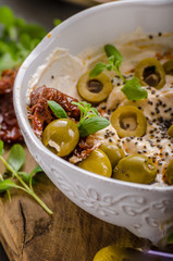 Fresh cheese with olives, dried tomatoes