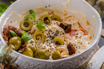 Fresh cheese with olives, dried tomatoes