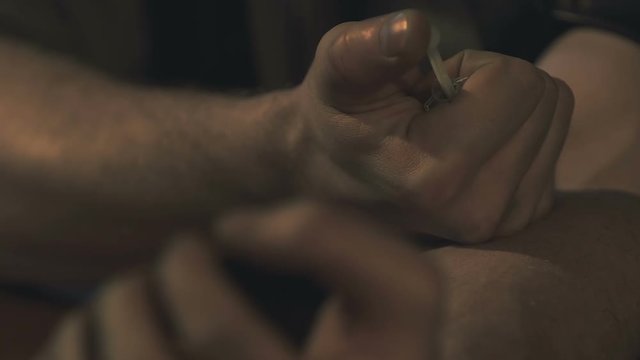 Drug addict male injecting heroin in arm, euphoric effect, forbidden drug using