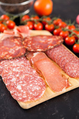 Delicious and healthy meat appetizers on wooden board