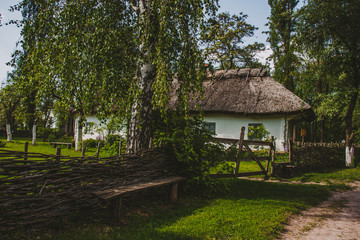 Fototapeta na wymiar Traditional cottage houses with the straw roofs, old village house, Ukraine