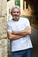 Mature man smiling looking at camera in urban background