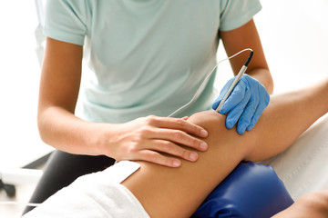 Fototapeta na wymiar Electroacupuncture dry with needle on female knee