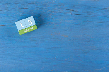 March 15, Cube calendar on wooden surface with copy space