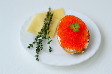 caviar sandwich on a white plate with cheese