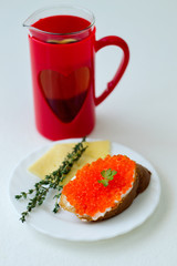 caviar sandwich on a white plate with cheese