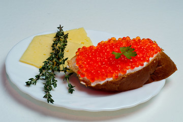 caviar sandwich on a white plate with cheese