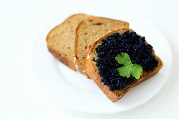 caviar sandwich on a white plate