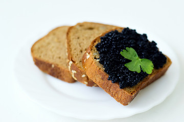 caviar sandwich on a white plate