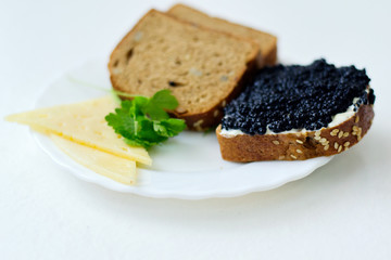 caviar sandwich on a white plate with cheese