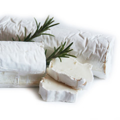 Fototapeta na wymiar Fresh goat cheese with rosemary isolated on white background