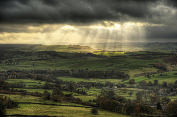 Beautiful sunbeams over Big Moor in the Peak District landscape in Autumn