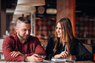 Man and woman sitting in cafe together, business lunch brake