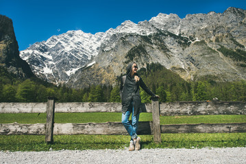 Fototapeta na wymiar Relaxed female traveller posing in front of mountain view enjoying the Alps in Austria. Freedom concept