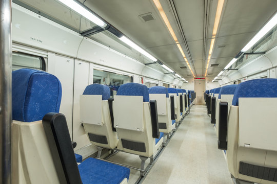Interior view of a modern empty passenger train car, with no one inside