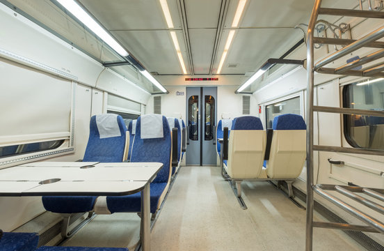 Interior view of a modern empty passenger train car, with no one inside