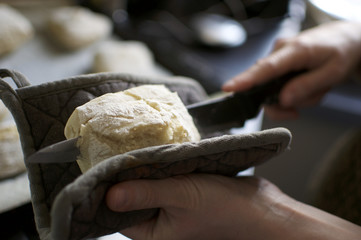 Slicing warm bread with bread knife