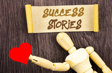 Text sign showing Success Stories. Conceptual photo Successful Inspiration Achievement Education Growth written Sticky Note Love Heart Holding By Sculpture the wooden background.