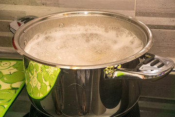 Italian woman cooks and season Italian pasta