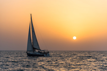Fototapeta na wymiar Sailing in the sea during sunset