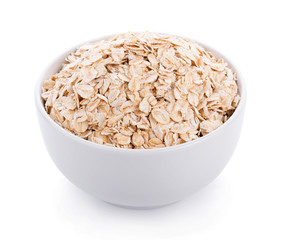 Oat flakes pile in white bowl on white background