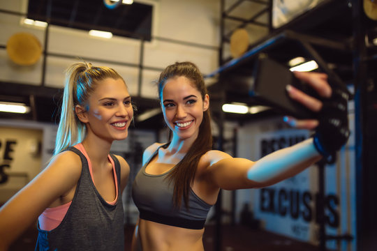 Portrait of young women taking a selfie in the gym.