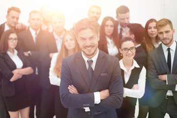 smiling businessman standing on background of her business team.
