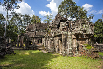 Angkor Wat - one of the temples in the khmer complex with trees and roots over the temple walls  in...