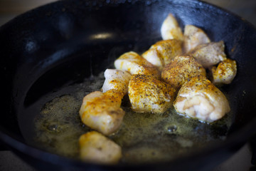 Fry meat in the pan. To cook the sliced meat with seasoning. Cooking meat with spices. 