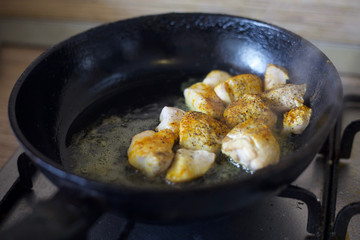 Fry meat in the pan. To cook the sliced meat with seasoning. Cooking meat with spices. 