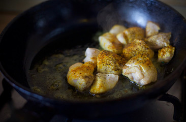 Fry meat in the pan. To cook the sliced meat with seasoning. Cooking meat with spices. 