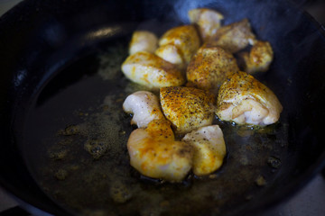 Fry meat in the pan. To cook the sliced meat with seasoning. Cooking meat with spices. 