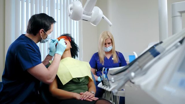 Dentist and his assitant working in private practice.