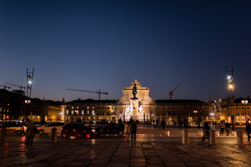 Naklejka na ściany i meble Praça do Comércio, important square of Lisbon, Portugal, night scene with people